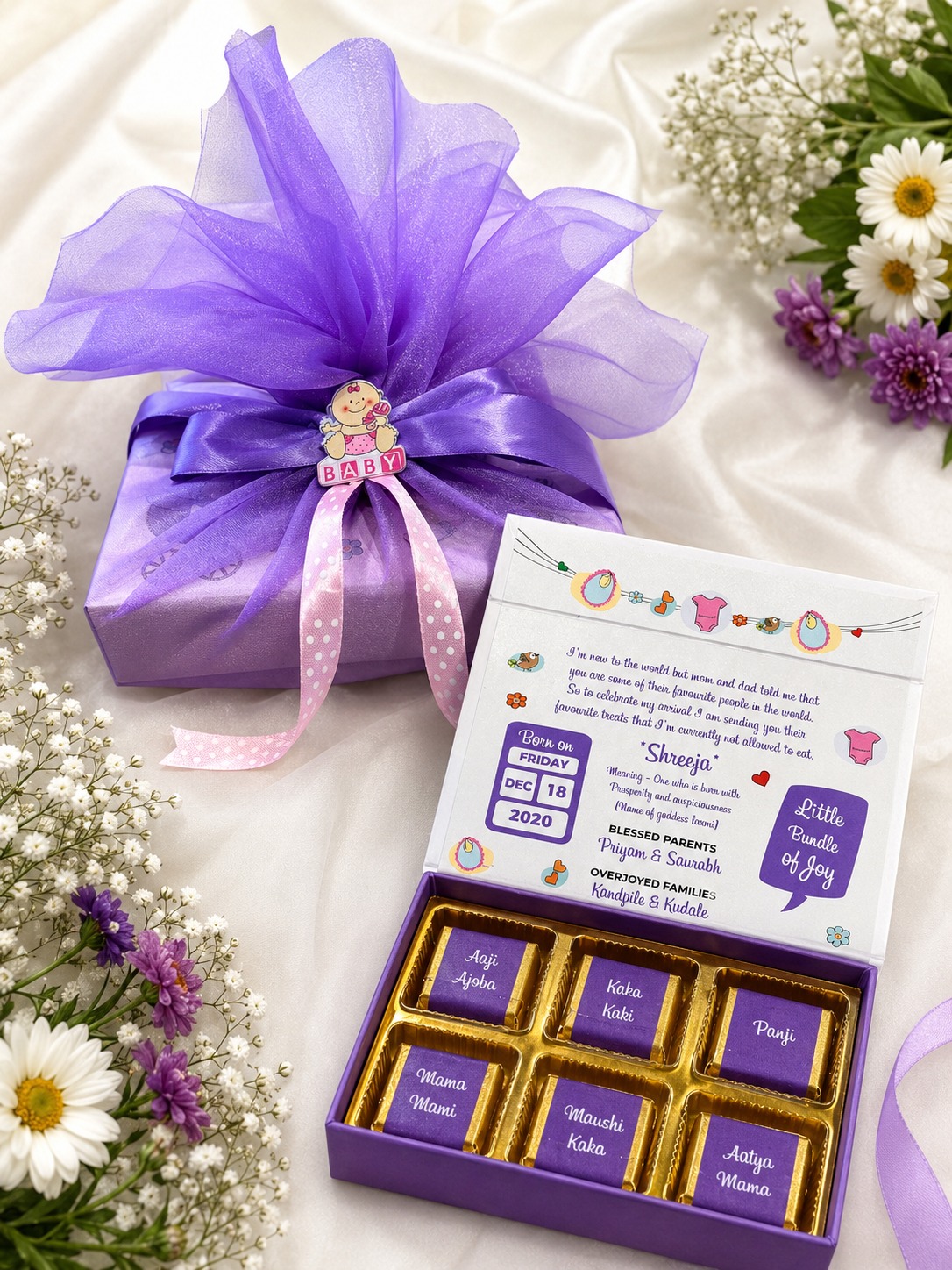 Purple tulle wrapped baby announcement box with named chocolates